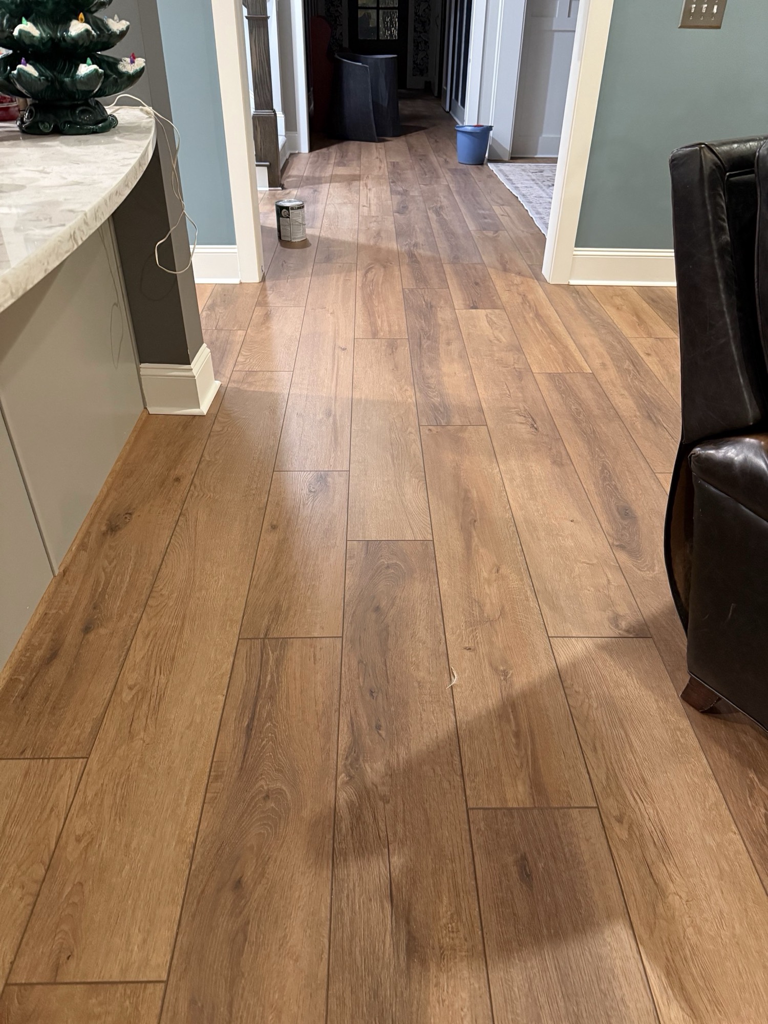 Warm wood-look plank flooring running clean through an open living space.